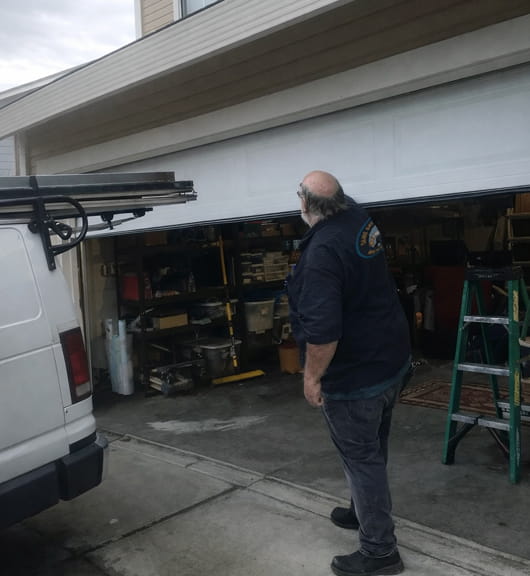 Larry inspecting a residential garage door in Walnut Creek