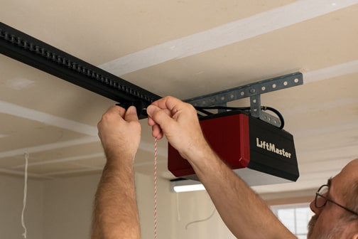 Larry repairing garage door opener system