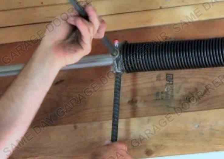 Larry replacing broken garage door torsion spring